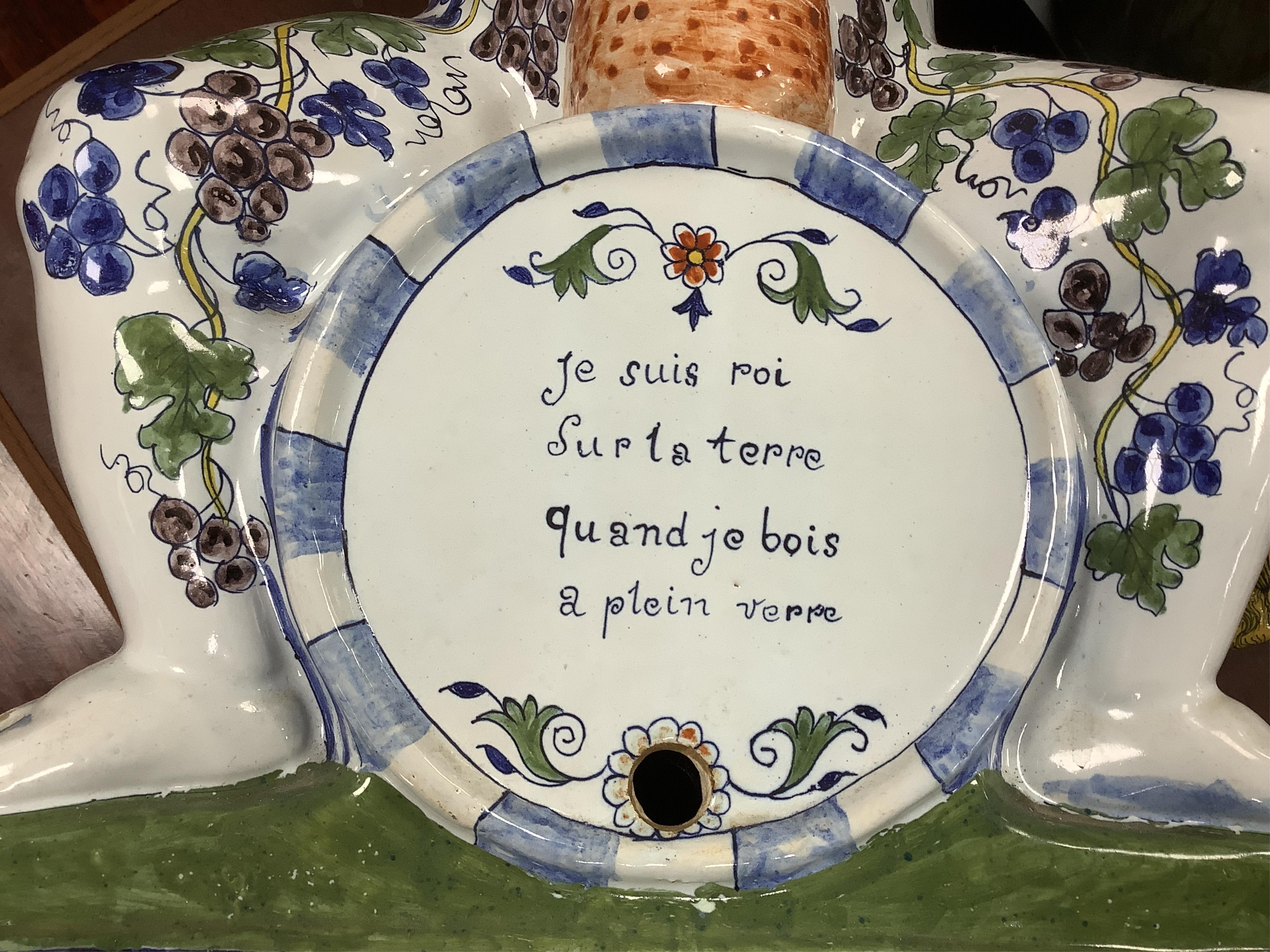 A large Brussels style faience Bacchus figural wine cistern, 62cm high